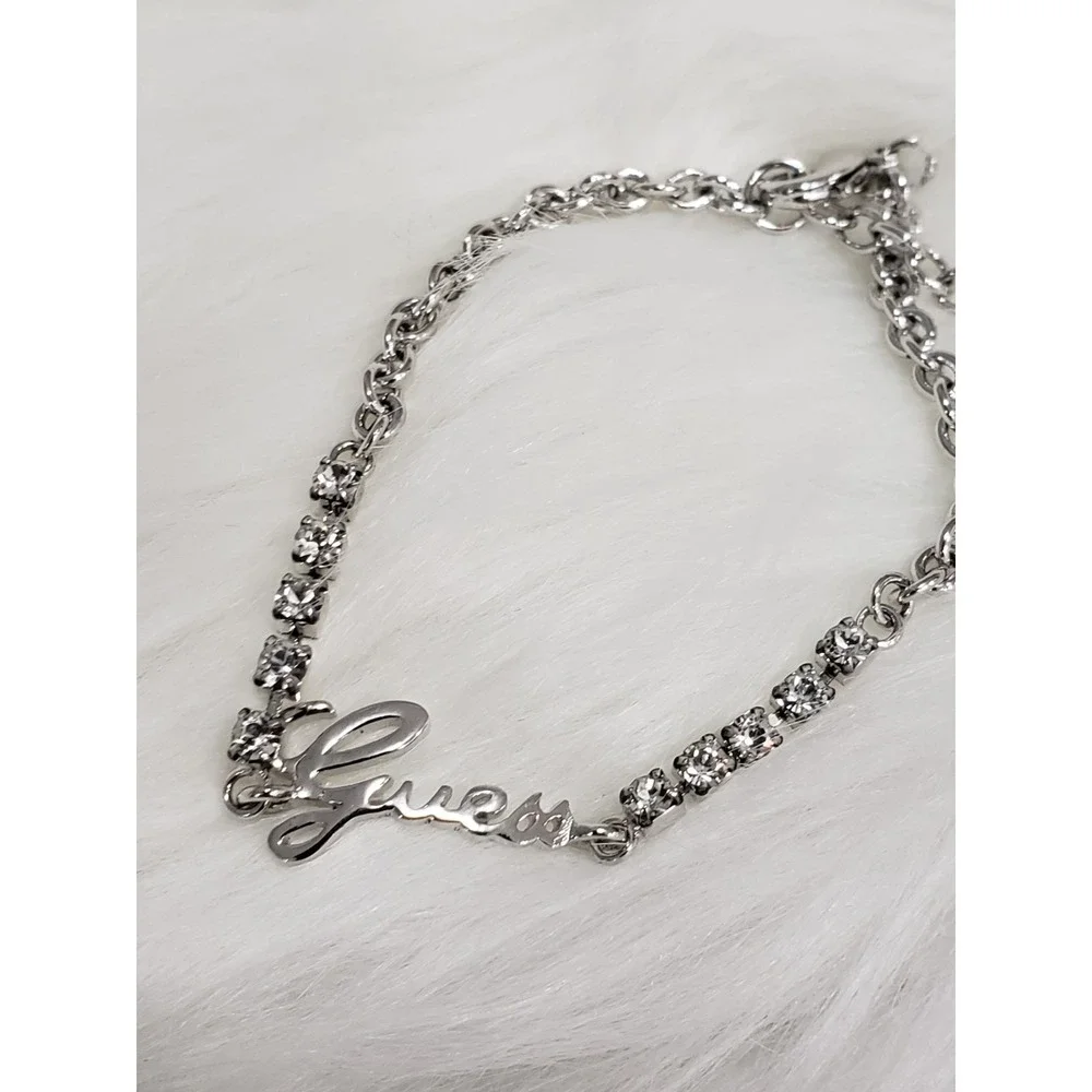 GUESS Clear Crystal Rhinestone Spell Out Logo Silver Tone Bracelet